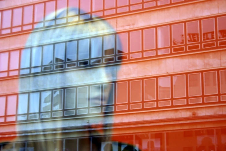 a reflection of a person outside behind some glass