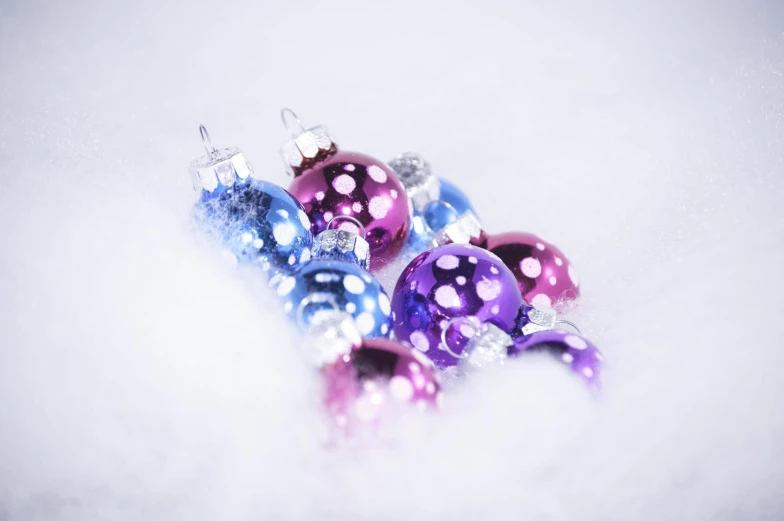 a group of ornaments with blue and pink ornaments