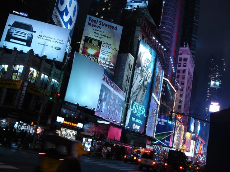 a street with tall buildings and cars at night