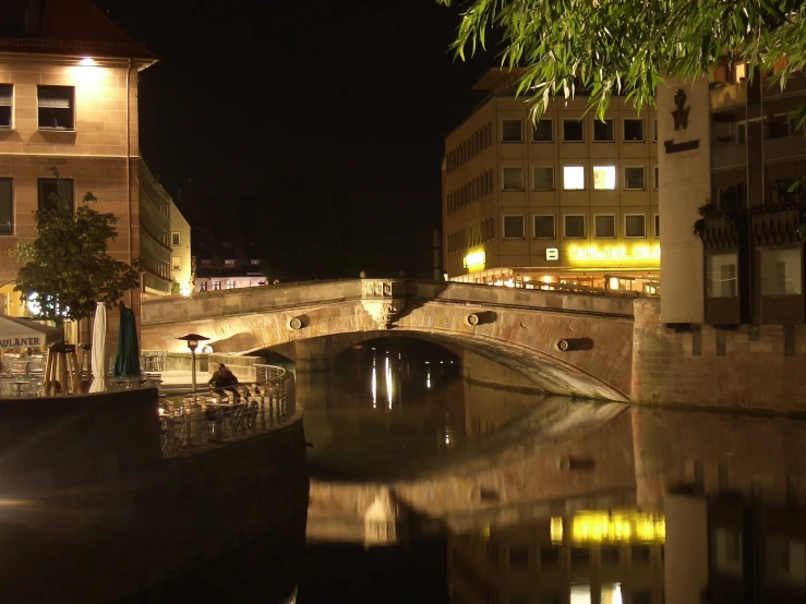 a very pretty bridge going over a small river