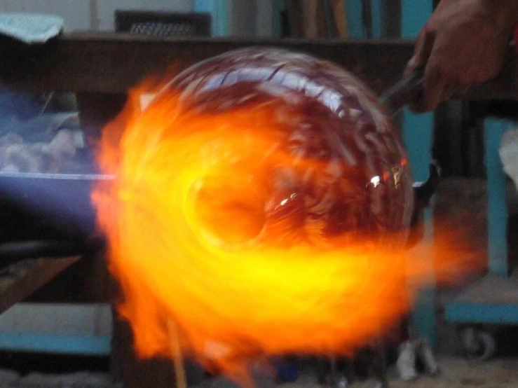a person using fire to make soing 