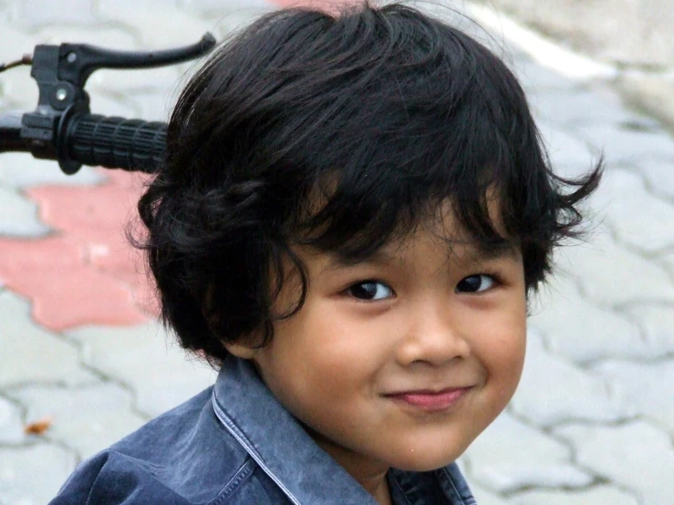 an infant is smiling with a motorcycle handlebar on it