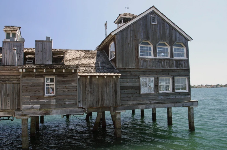 the front end of a building sitting on the water