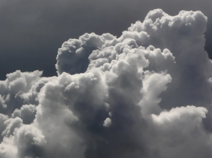 the sky has white clouds covering it in shades