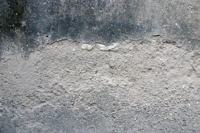 a textured concrete surface is very worn and weathered