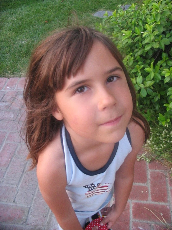 a little girl holding a toy in her hand