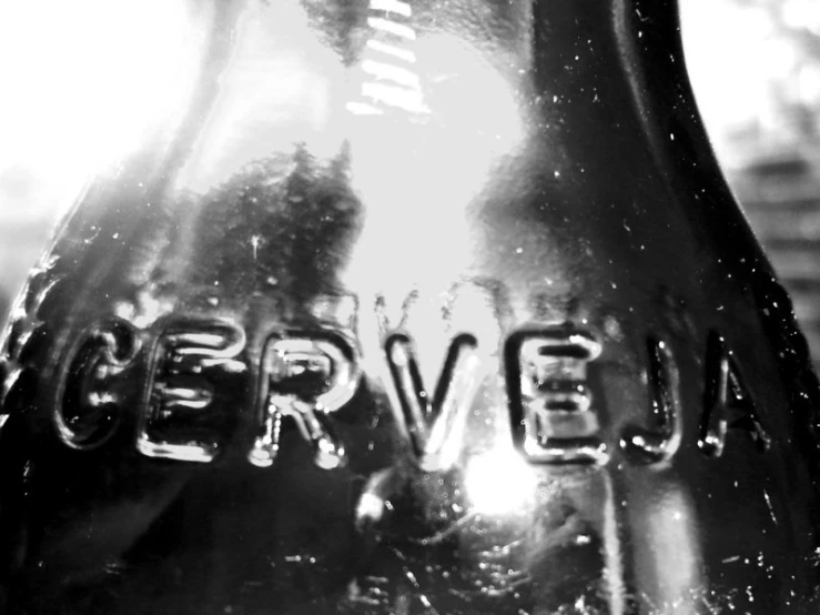 the side view of a black and white po of a glass bottle