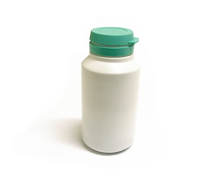 an empty white plastic bottle sitting on top of a white surface