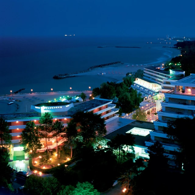 a view of the beach and a city at night