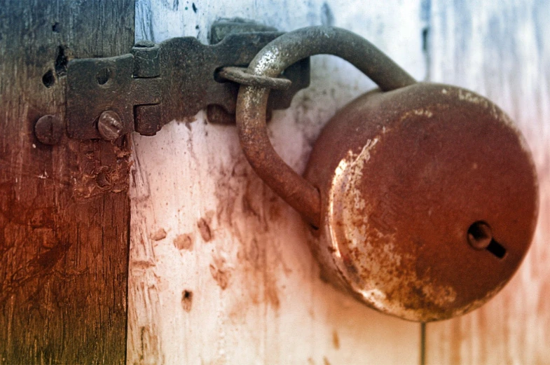 a rusted padlock with an opening and a missing lock