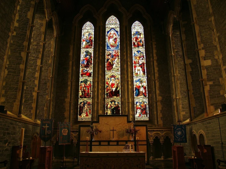 an old cathedral with stained glass windows and pews