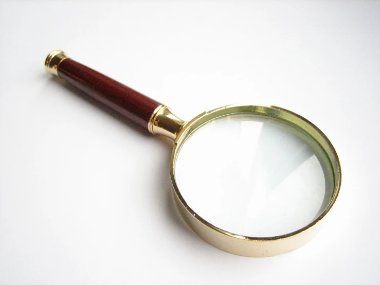 a magnifying glass laying on a white surface