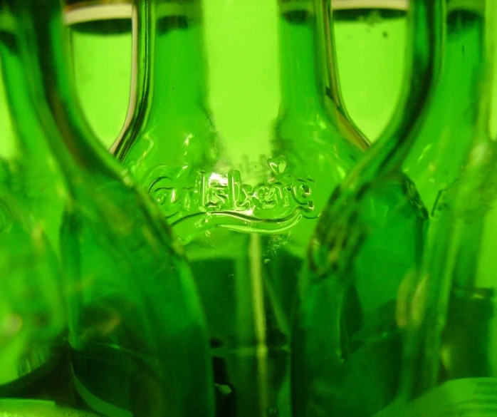 the green glass jars are lined up neatly