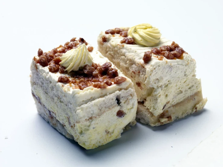 a pastry has cream cheese and nuts on it