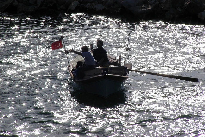 a man and two women are in a boat