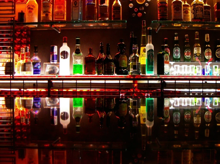 a shelf filled with bottles filled with various liquors