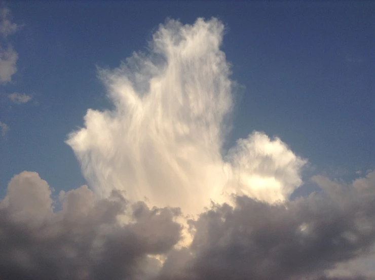 the clouds are floating over the skyline on a sunny day