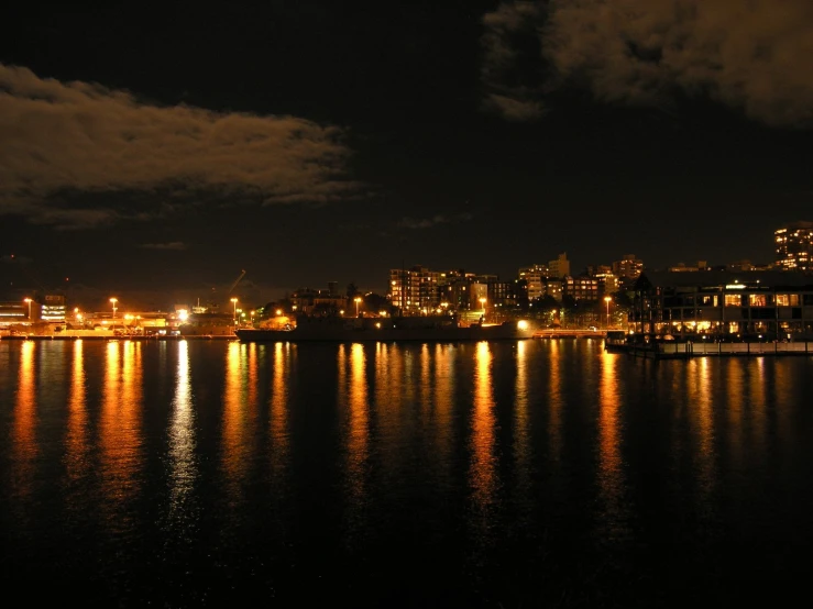 a harbor area with buildings lights reflecting in the water