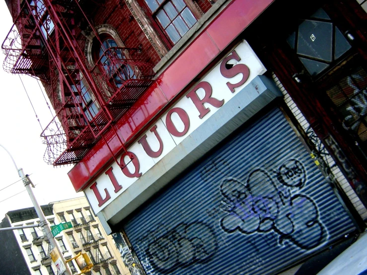 a large red and white sign on a building with a ladder