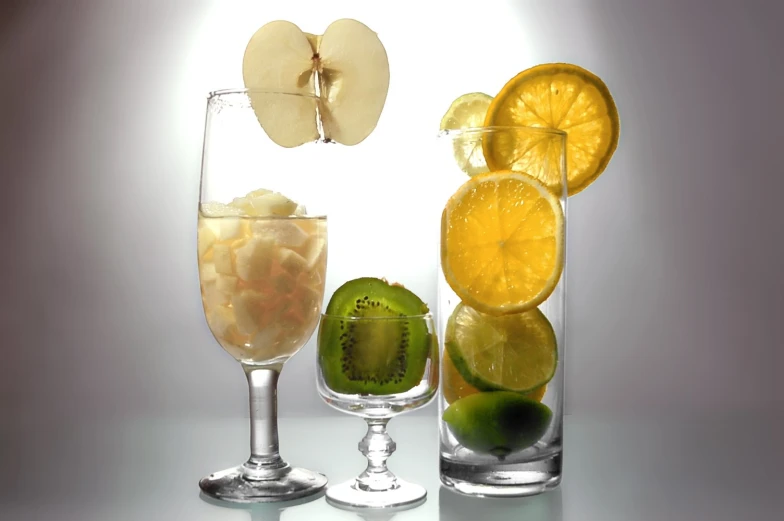 some fruit that are on the table with a glass