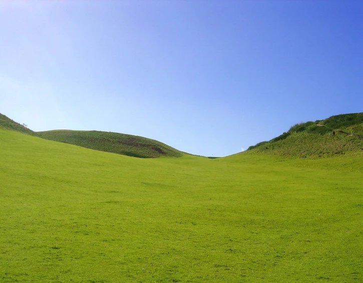 there are green hills next to each other