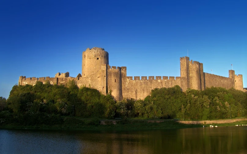 a large castle with trees next to it