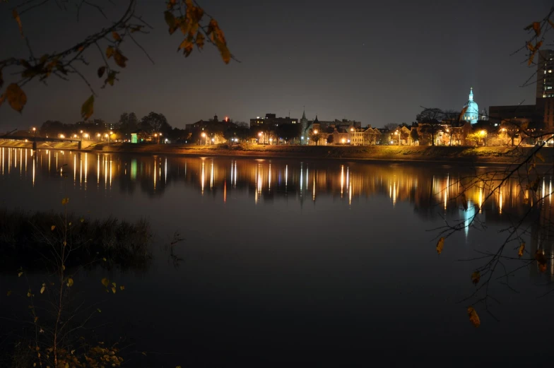 city skyline with reflection on surface at night