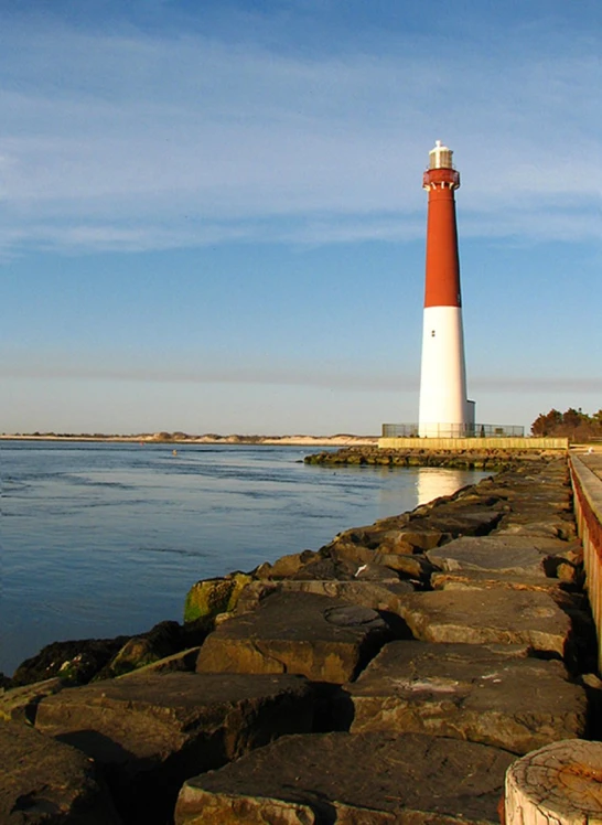 a long brick walkway next to the ocean