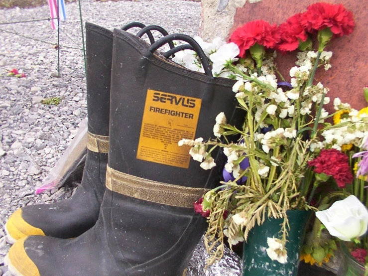 a pair of rubber boots with flowers and signs on them