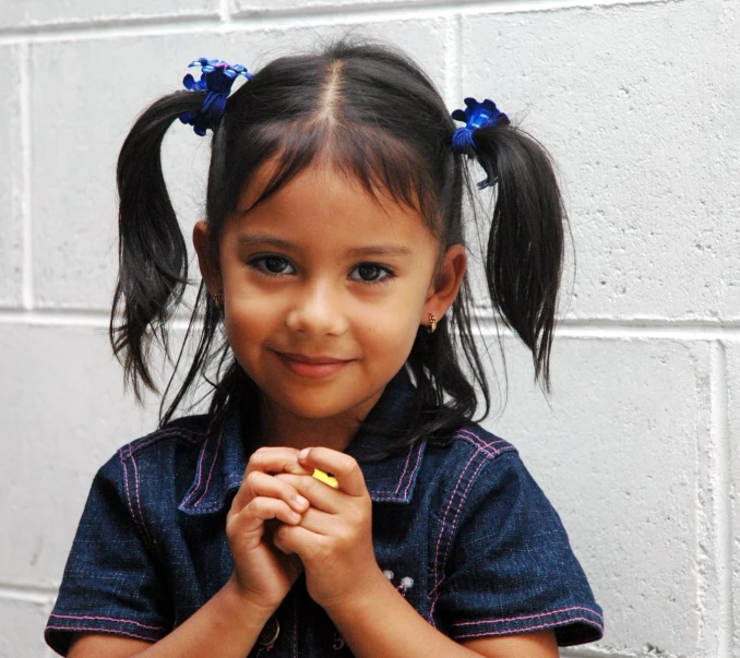 a child that is holding soing in her hands