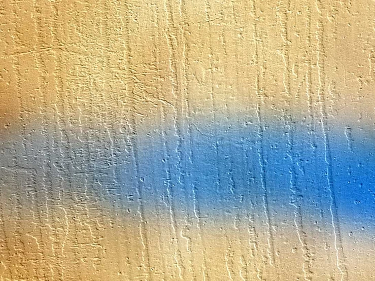 an abstract pograph with blue and white paint on a wall