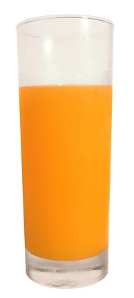 a glass with orange liquid sitting on top of a table