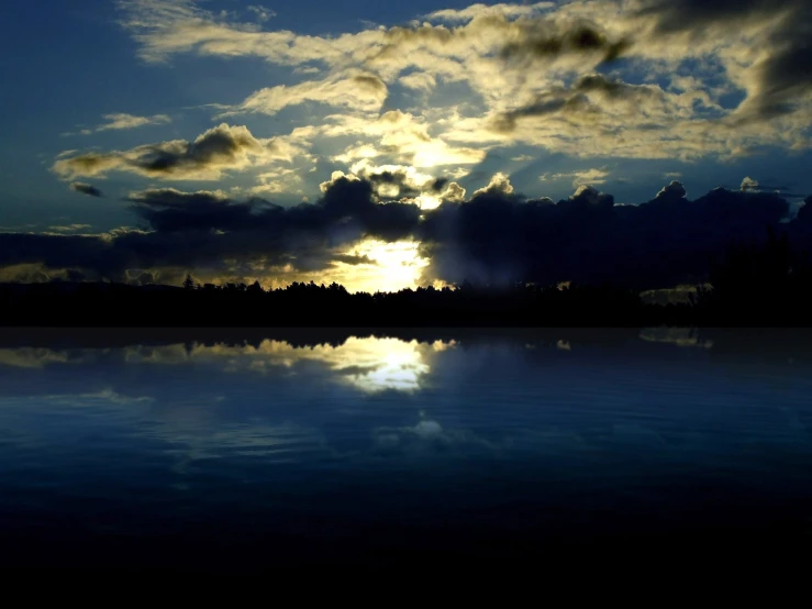 a beautiful sunset over some water and clouds