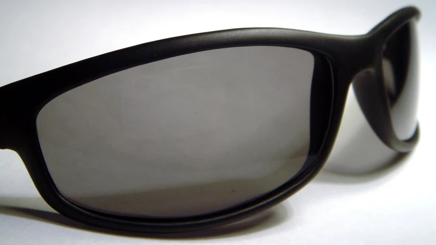 a pair of black sunglasses is sitting on a table