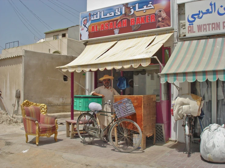 a man sits in his small store with old bikes and other items