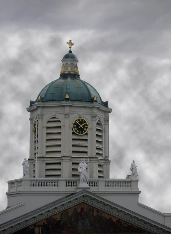 a white and gold clock sitting on top of a building