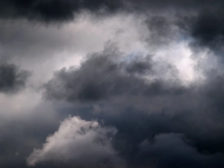 a plane is in front of some very dark clouds