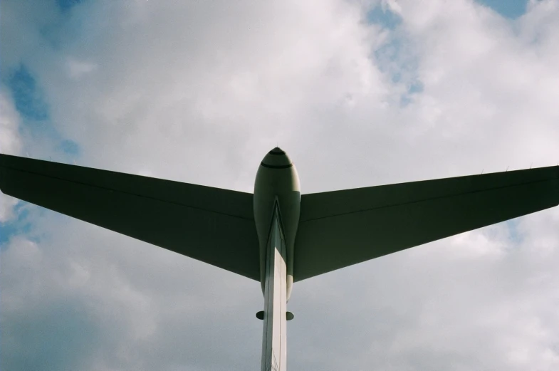 an airplane flying in the sky over a few clouds