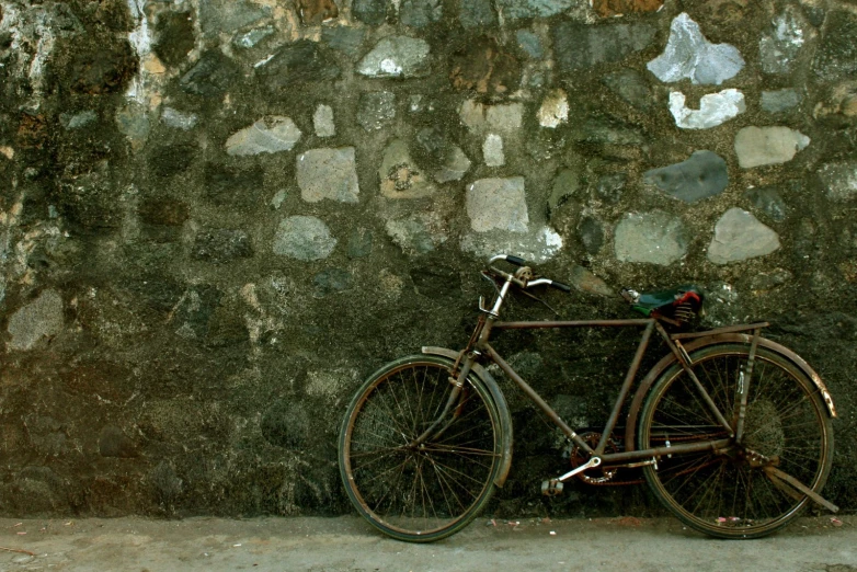 a bike that is leaning against a wall