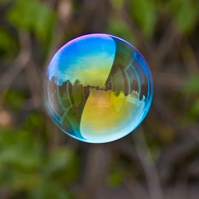 a soap bubble in the air with a reflection