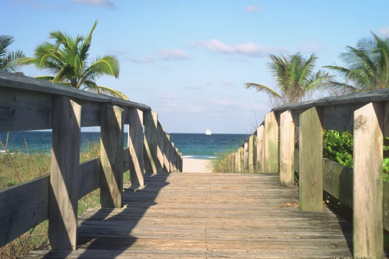 a path that leads to the beach and ocean