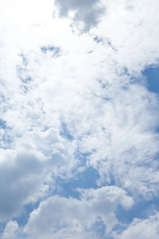 a lone plane flying in a cloudy sky