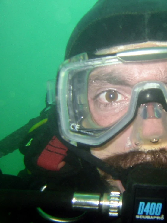 a man with a beard wearing a diving mask and goggles