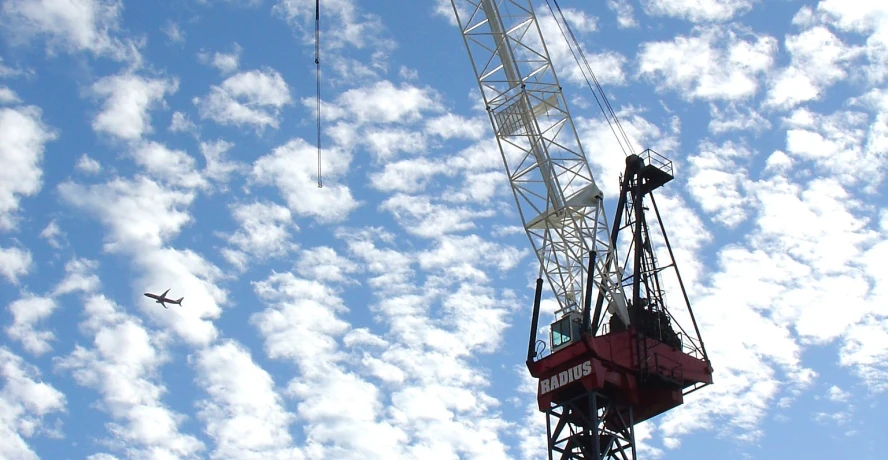 two cranes sitting on top of a construction site