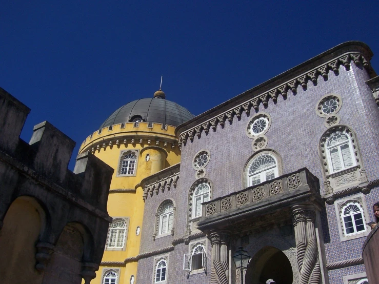 two large buildings sitting next to each other on a clear day