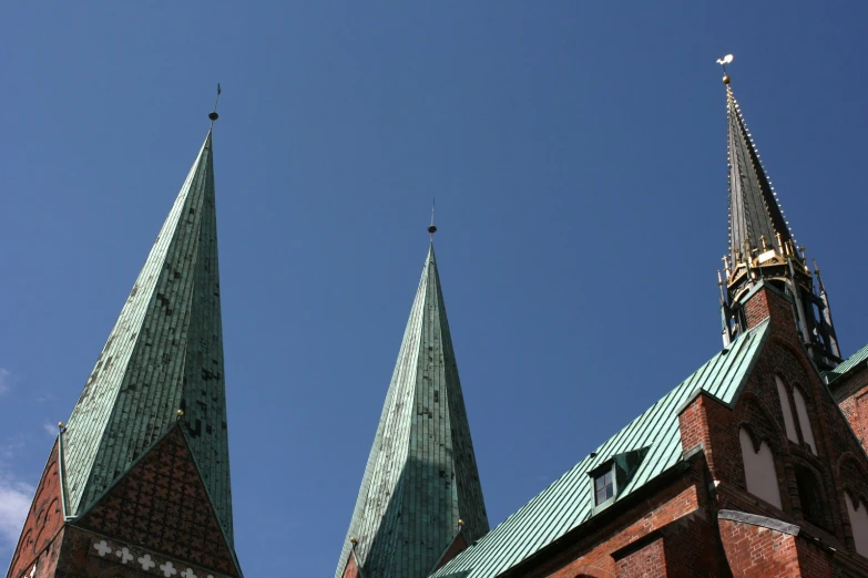 two large spires on the roof of an old church