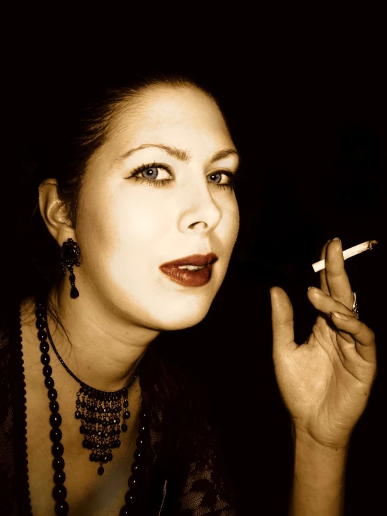 a woman smoking a cigarette in the dark