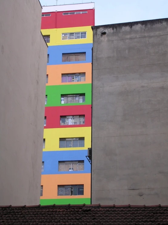 colorful building painted in different colors next to buildings
