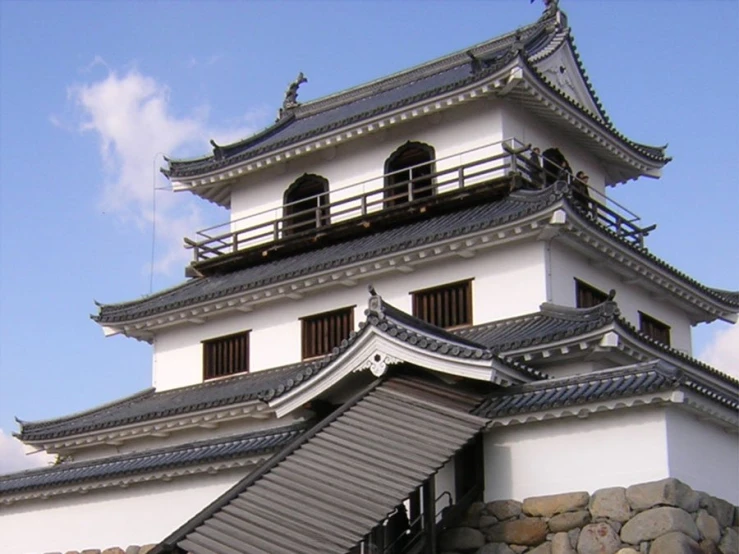 a white building with a long iron fence