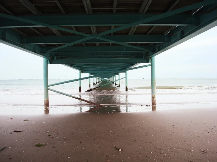 the underside of a covered beach by water